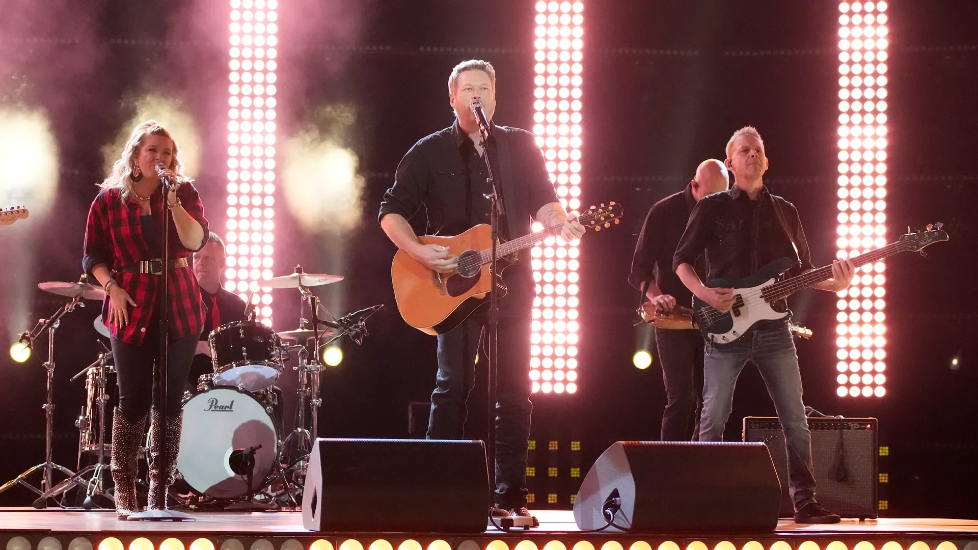 Full country band performing on a bright stage